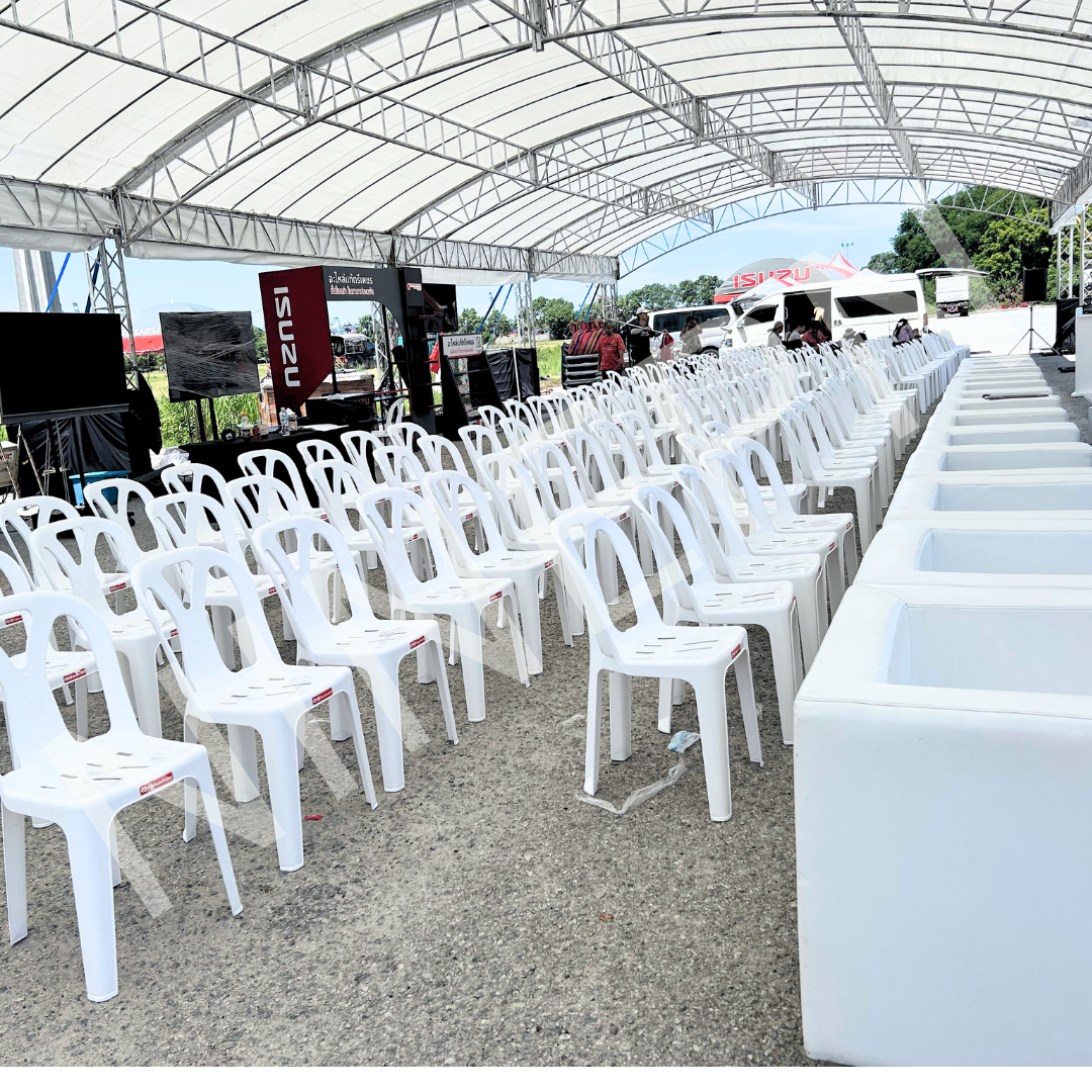 เซ็ตเก้าอี้พลาสติกสีขาวสะอาดคู่กับโซฟา VIP ใต้เต็นท์ผ้าใบจัดงาน โดย NINE PN